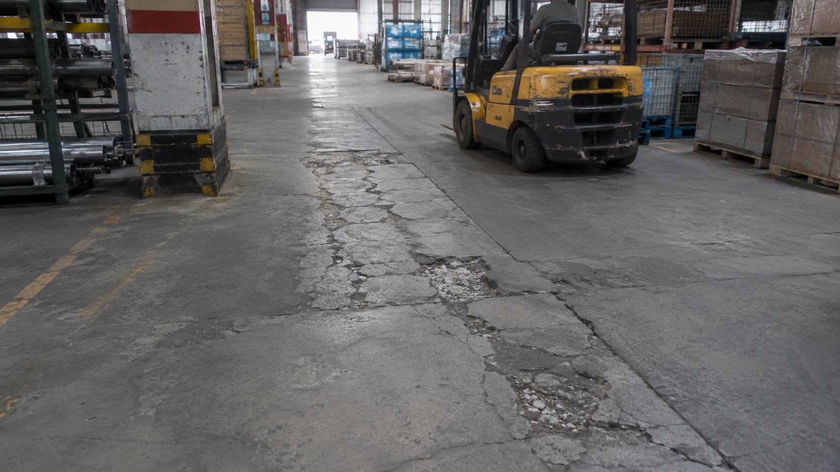 Damaged forklift traffic route in an industrial warehouse