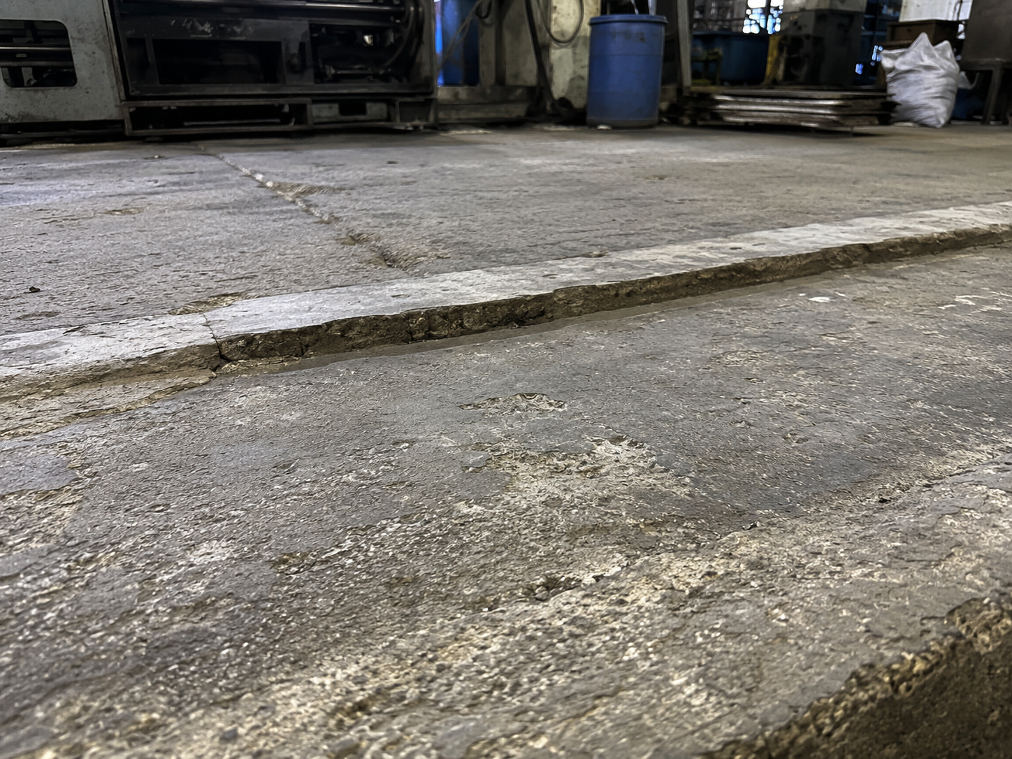 Sunken and damaged area in an industrial concrete floor